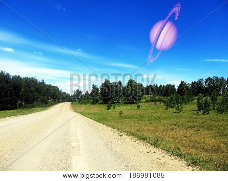 The planet Saturn in the blue sky.
