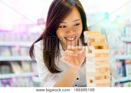 Asian Lady Play Jenga Game