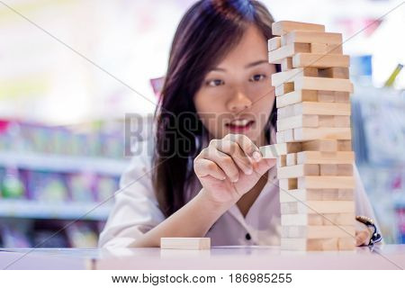 Asian Lady Play Jenga Game