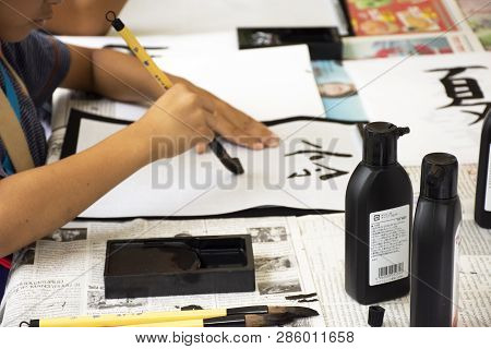 Travelers People Join With Use Paintbrush Writing Japanese Activity In Tanabata Festival At Japan Vi