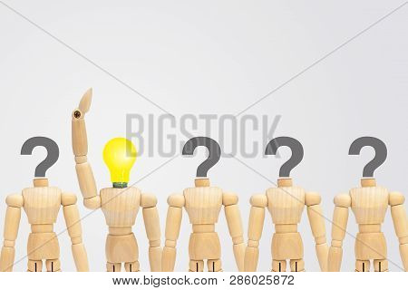 One Wooden Figure Mannequin With Light Bulb Head Standing Out Row Of Other Figures With Question Mar