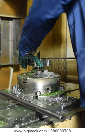 The Worker Installs A New Metal Part In The Chuck Spindles For Processing On The Cnc Machine. Hands 