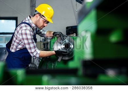 Factory Worker Measure Detail With Digital Caliper Micrometer During Finishing Metal Working On Lath
