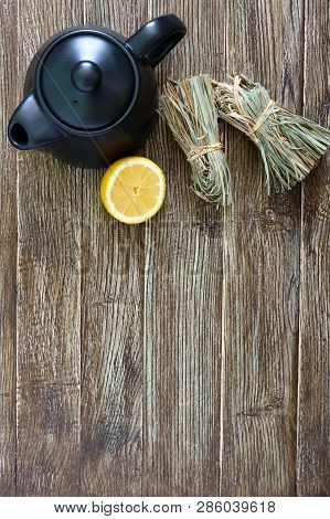Organic Dry Lemongrass (cymbopogon Flexuosus) In Bunches And Lemon Fruit On A Wooden Table. Herbs Fo