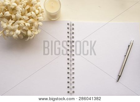 Flowers, Notebooks On A White Wooden Table That Looks Relaxed