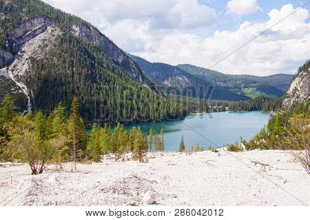 Mudflow In The Alpine Mountains With Lake On Background