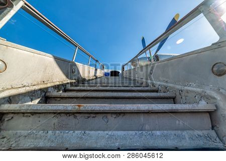 Old, Worn Passenger Gangway. Gangway Attached To The Aircraft.