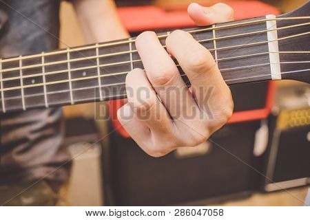 Musician Playing Acoustic Guitar, Classical Guitar Fretboard With Metal Strings And Hand.