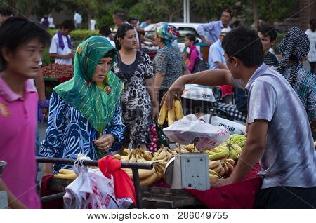 Turpan, China - August 11, 2012: People At A Street Market In The City Of Turpan, Xinjiang Region.