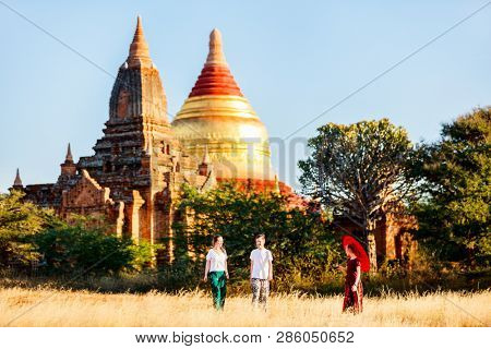 Family of mother and kids visiting Dhammayazika Pagoda and ancient temples in Bagan Archeological area in Myanmar