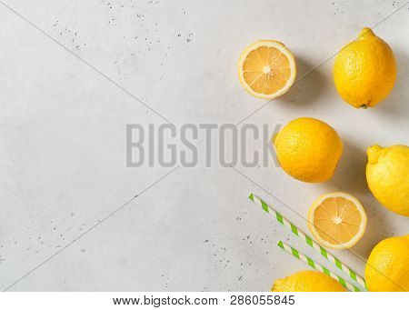 Ripe Lemons Frame With Straw On White Table Background. Lemonade Concept. Copy Space, Top View