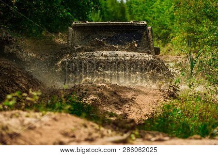 Mud And Water Splash In Off-road Racing. Tracks On A Muddy Field. Expedition Offroader. Track On Mud