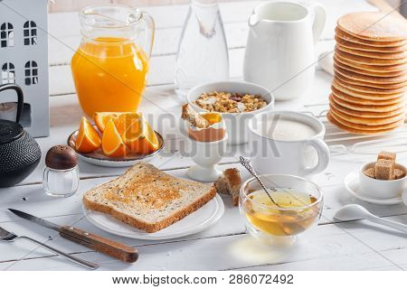 Healthy Breakfast Eating Concept, Various Morning Food - Pancakes, Soft-boiled Egg, Toast, Oatmeal, 