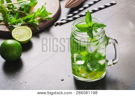 Mojito Cocktail In Mason Jar With On Black Stone Table. Copy Space For Text.