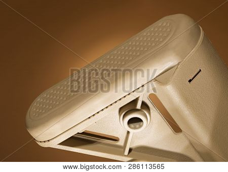 Assault Rifle Recoil Pad That Is On A Tan Background