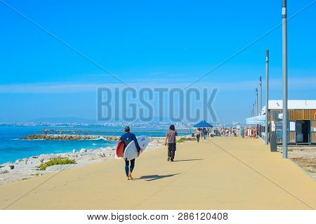 Costa Da Caparica, Lisbon, Portugal - September 17, 2018: People Walking By Seaside Promenade In The