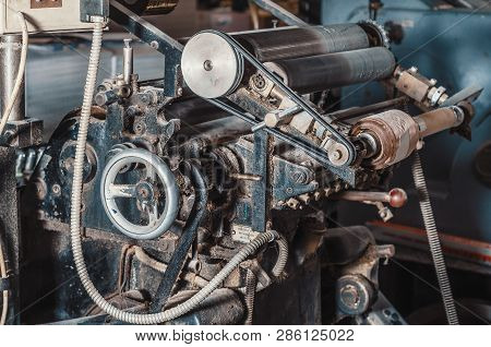 Vintage Printing Machine For Carving In Printing. Part Of The Old Mechanism, Regulators, Gears.
