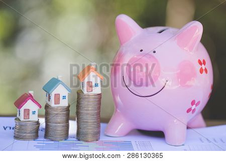 Mini House On Stack Of Coins,money And House,  Mortgage, Savings Money For Buy House And Loan To Bus
