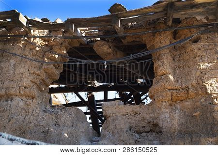 Ruins Of An Old Town House Made Of Adobe.
