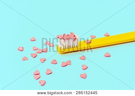 Love Concept Minimal. Bright Colorful Background With Teethbrush And Candy Hearts In Pink And Turquo