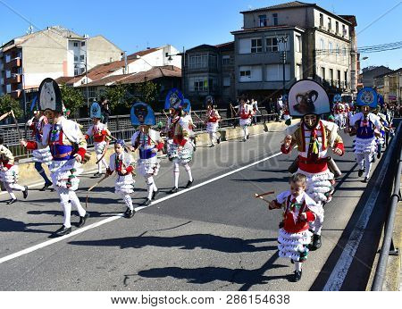 Verin, Spain, 24 Feb 2019. Famous Carnival And Street Parade With Cigarrons Costumes. Ourense Provin
