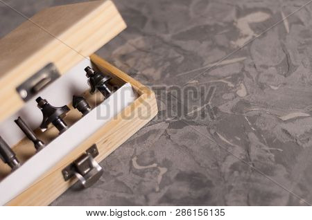 Set Of Steel Router Bit For Milling Cutter In Rectangle Wooden Box With Metal Lock On Old Broken Wor