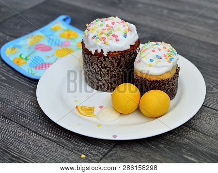 Easter Cake With Easter Eggs On A White Plate On Wooden Background