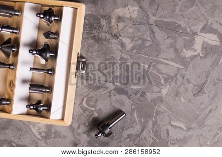 Set Of Steel Router Bit For Milling Cutter In Rectangle Wooden Box With Metal Lock Near One Bit On O