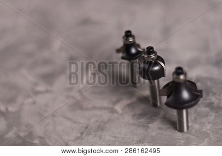 Row Of Three Steel Router Bits For Milling Cutter On Old Broken Worn Gray Concrete Floor With Copy S