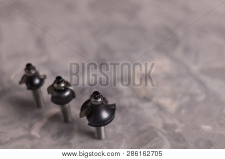 Row Of Three Steel Router Bits For Milling Cutter On Old Broken Worn Gray Concrete Floor With Copy S