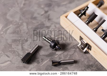 Set Of Steel Router Bit For Milling Cutter In Rectangle Wooden Box With Metal Lock Near Three Bits O