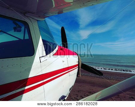 A Small Plane  On A Remote Beach In Alaska