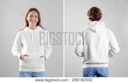 People In Blank Hoodie Sweaters On Light Background, Front And Back Views. Mock Up For Desing