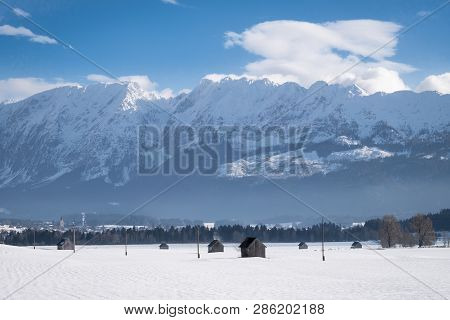 Some Clouds Around Snow Covered Mountain Range With Mountains Grimming, Schartenspitze And Steinfeld