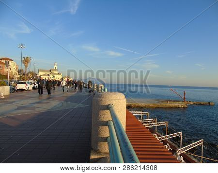 Genova, Italy - 02/14/2019: An Amazing Caption Of The Sunset Over The Sea And The City Of Genoa In W