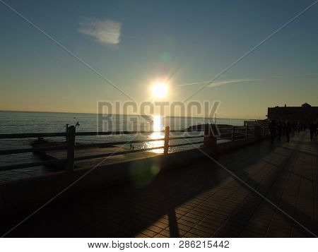 Genova, Italy - 02/14/2019: An Amazing Caption Of The Sunset Over The Sea And The City Of Genoa In W