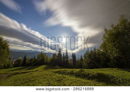 Summer Night Mountain Panorama. Green Grassy Mountain Clearing On Cloudy Evening Sky Copy Space Back