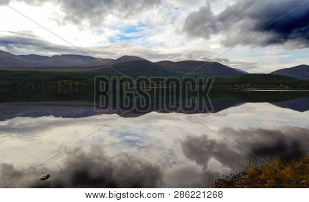 Relections Of The Cairngorms On Loch Morlich In The Cairngorms National Park, Scotland.