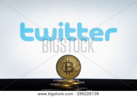 Bitcoin On A Stack Of Coins With Twitter Logo On A Laptop Screen. Cryptocurrency And Blockchain Adop