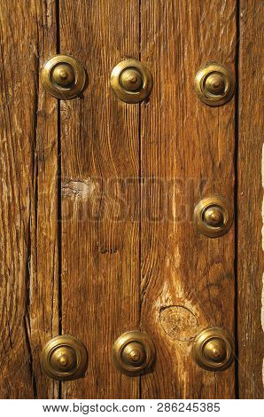 Bronze Studs Attached To Wooden Planks At Caceres