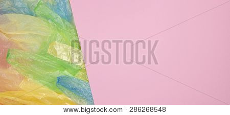 Multicolored Single Use Plastic Shopping Bags With Blank Pink Background For Text Or Image