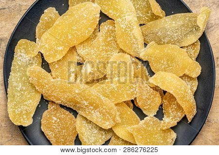 crystallized ginger slices on black plate