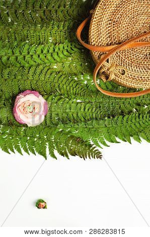 Fashionable Handmade Natural Organic Rattan Bag And Green Fern Leaves, Pink Flower Isolated On White
