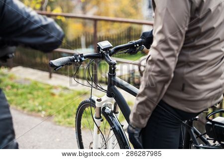 A Midsection Of Active Senior Couple With Electrobikes Cycling Outdoors.