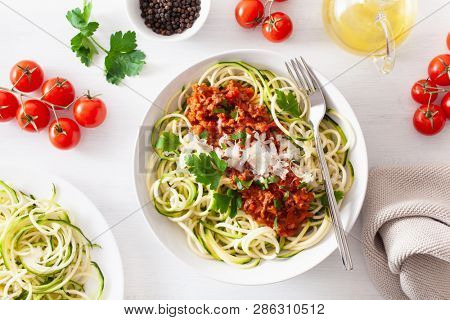 keto paleo zoodles bolognese: zucchini noodles with meat sauce and parmesan