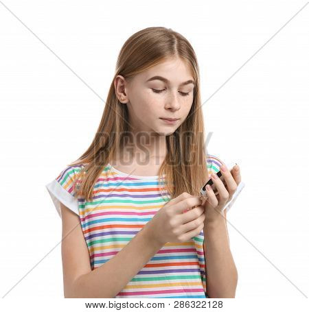Teen Girl Using Glucometer On White Background. Diabetes Control