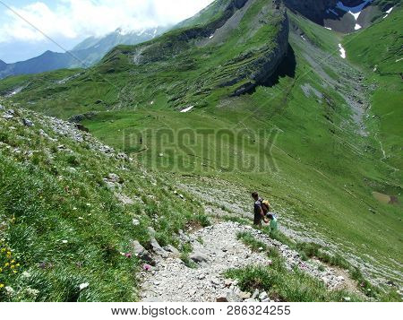 Mountain Hikers On The Alpine Peak Of Margelchopf In The Alviergruppe Mountain Range - Canton Of St.