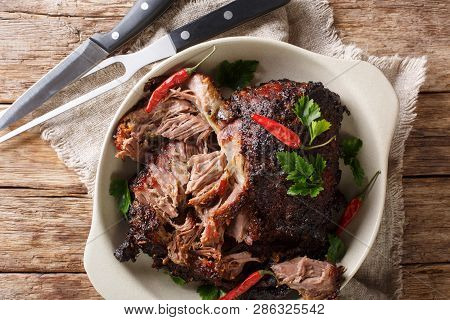 Delicious Spicy Slow Shredded Pulled Pork Closeup On A Plate. Horizontal Top View