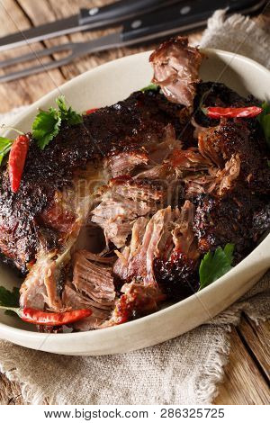 Slowly Cooked Shredded Pulled Pork Close-up On A Plate. Vertical