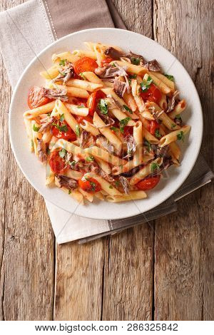 Serving Penne Pasta With Pulled Pork, Cheese, Tomato Sauce And Herbs Close-up On A Plate. Vertical T